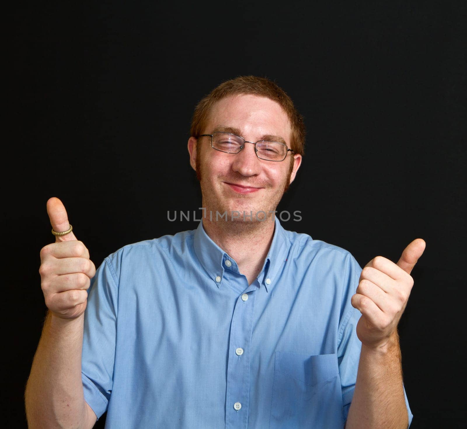 smiling young man with thumbs up