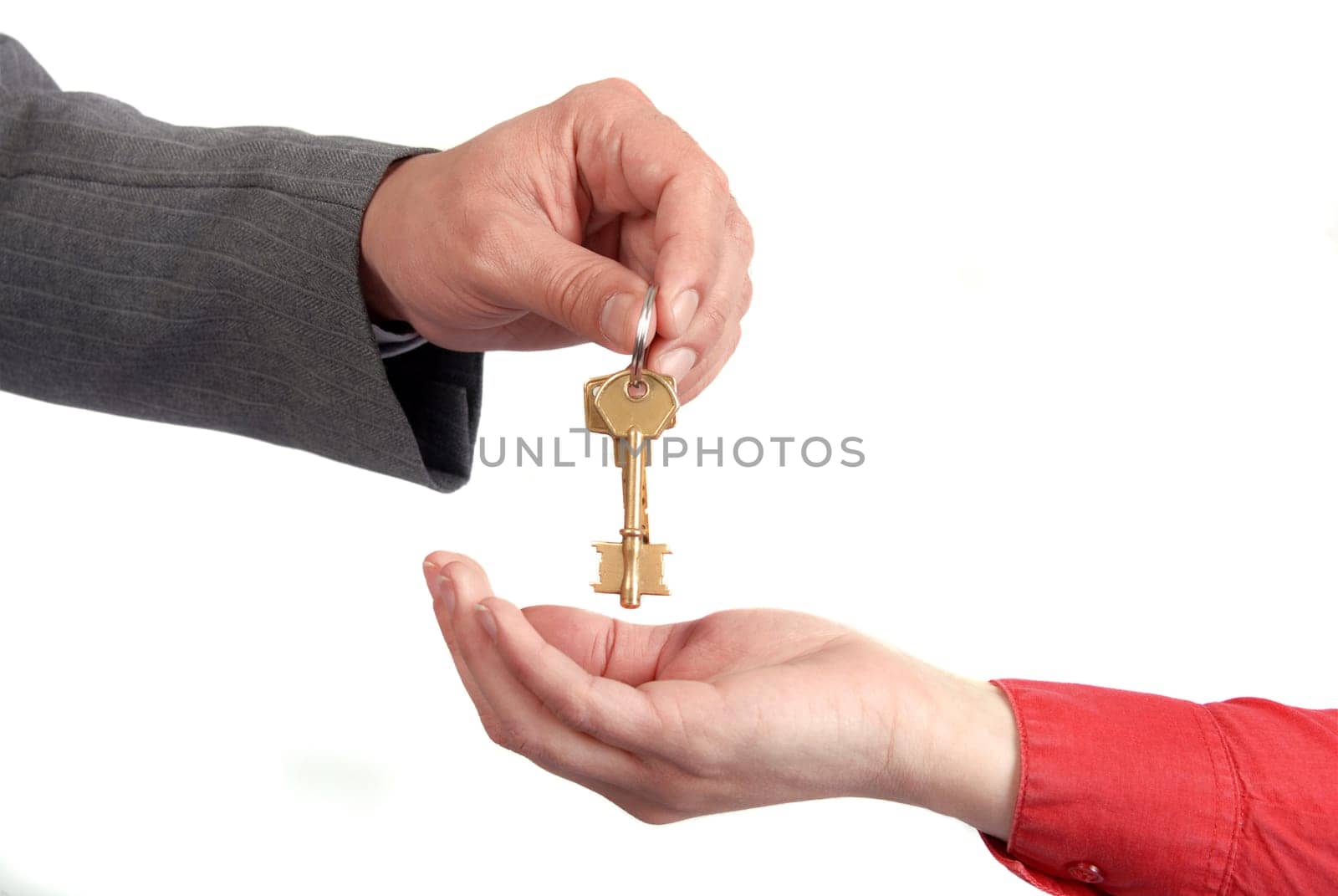 Businessman handing a key to success over a woman palm.