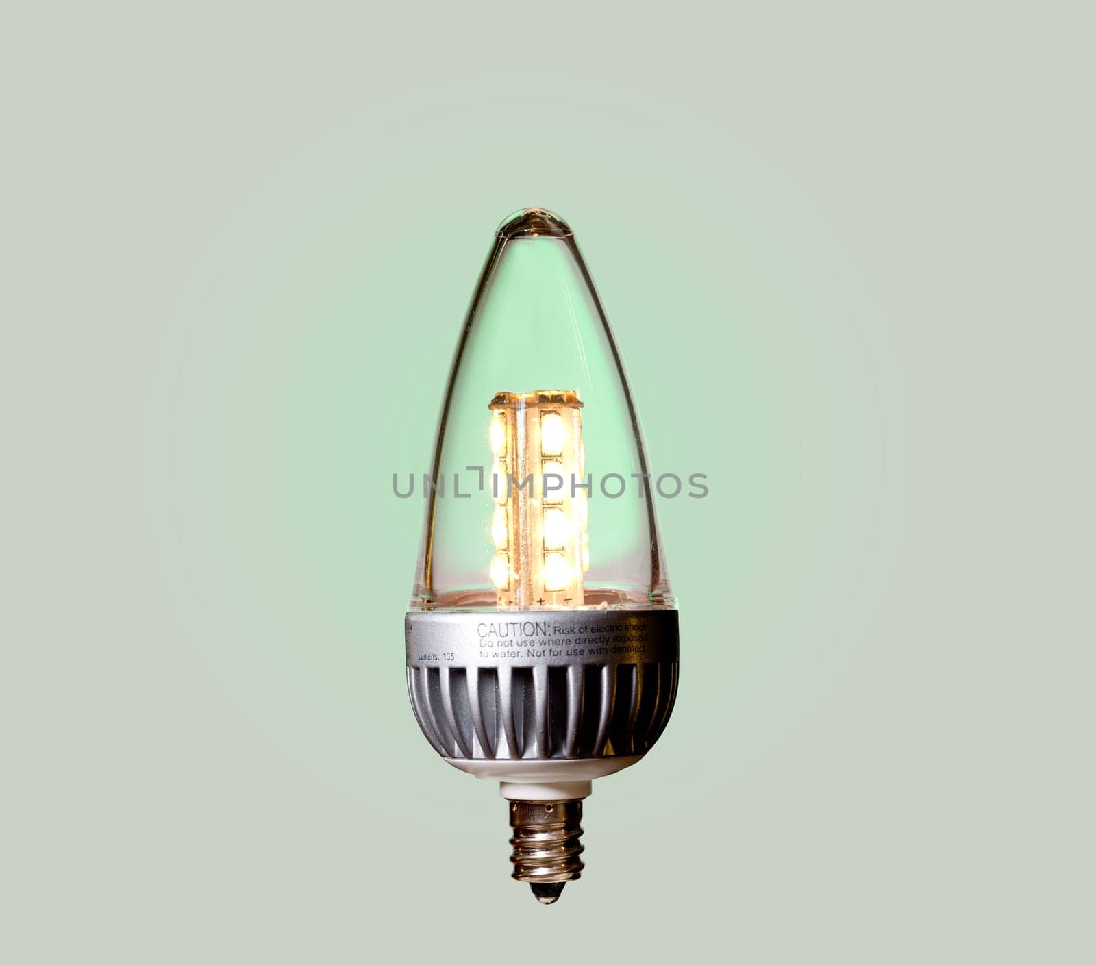 Illuminated LED bulb set against green ecological background with paths of main components included