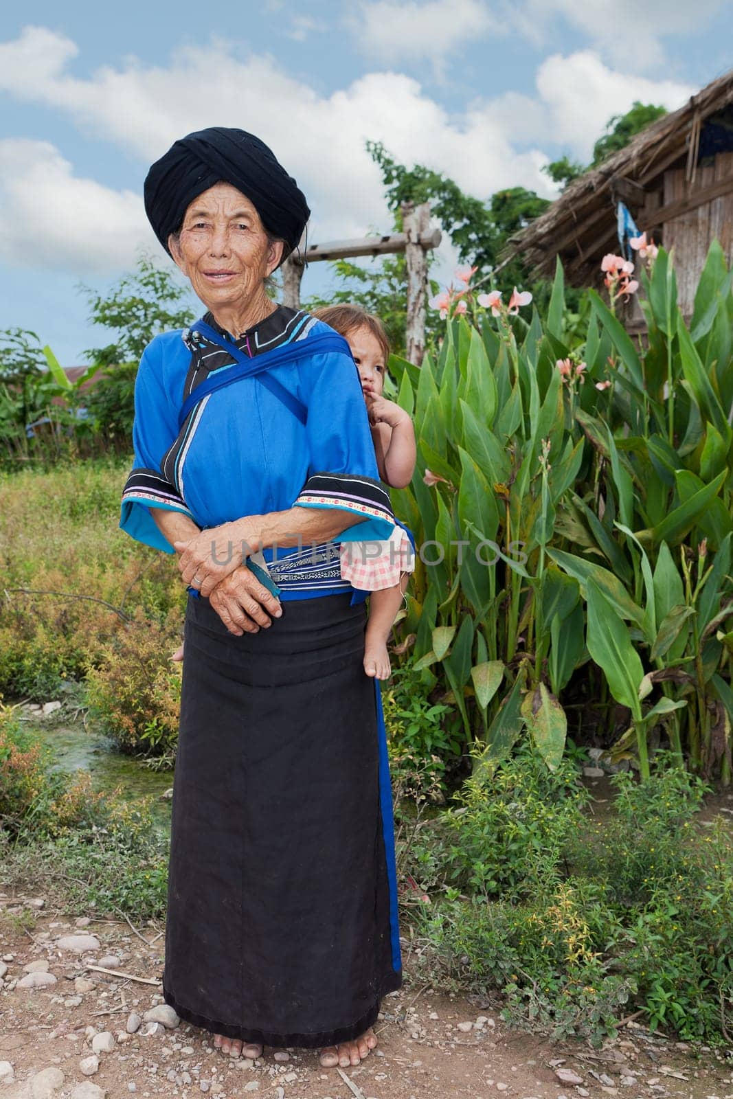 Grandmother with grandson,asian ethnic group Lolo in traditional costume