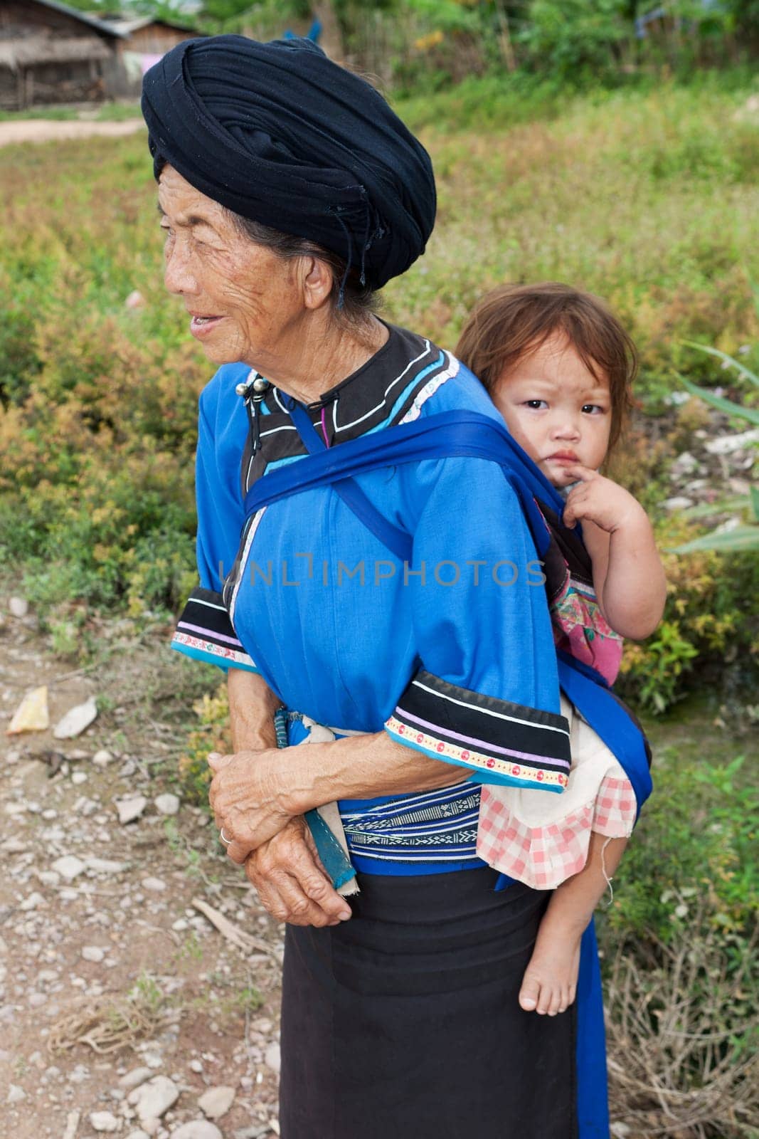 Grandmother with grandson,asian ethnic group Lolo in traditional costume