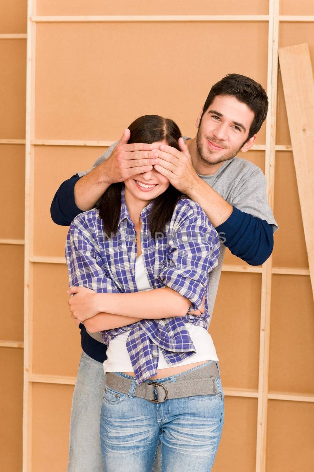 New home improvement young couple man cover eyes happy woman