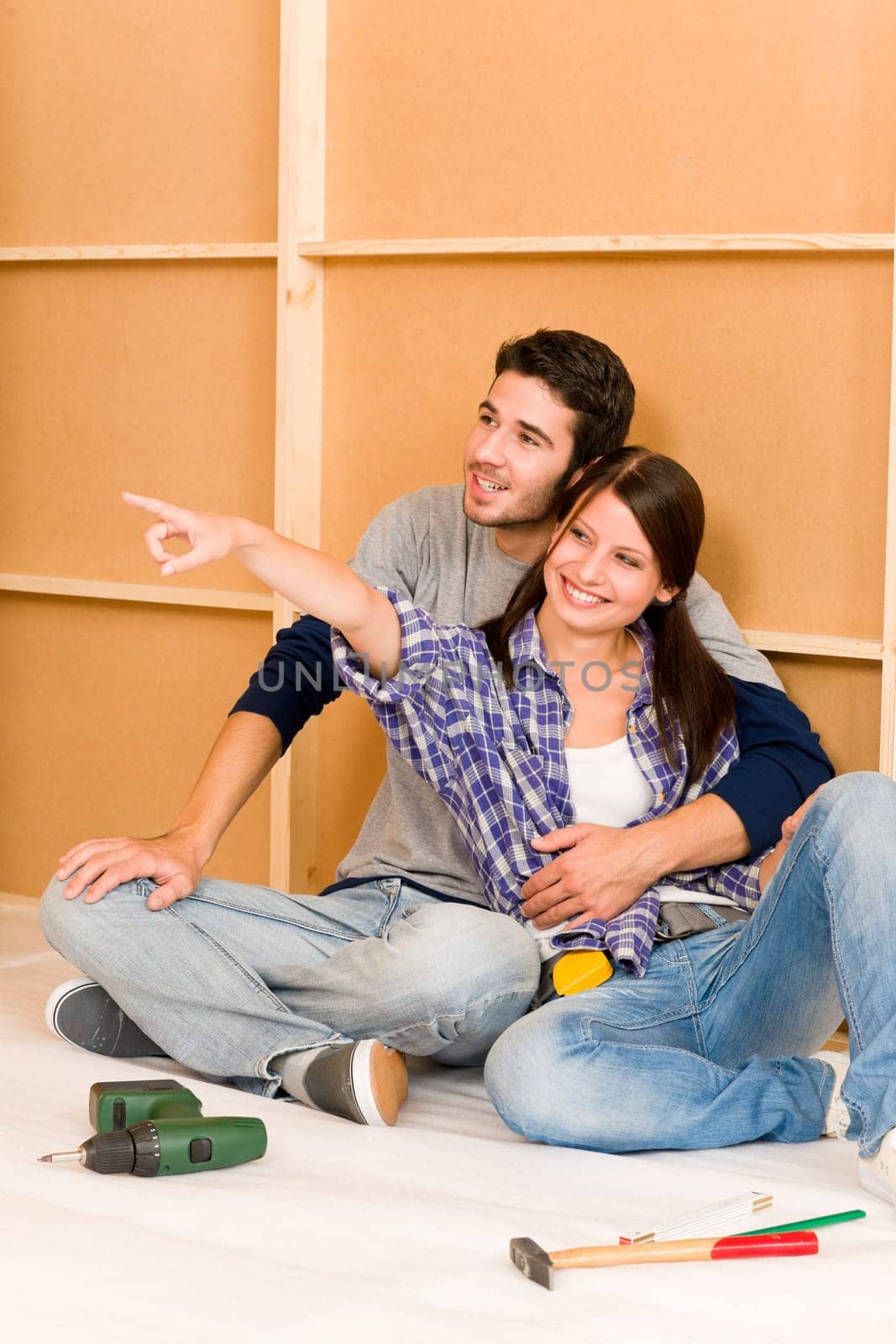 Home improvement young happy couple repair tool relax on floor