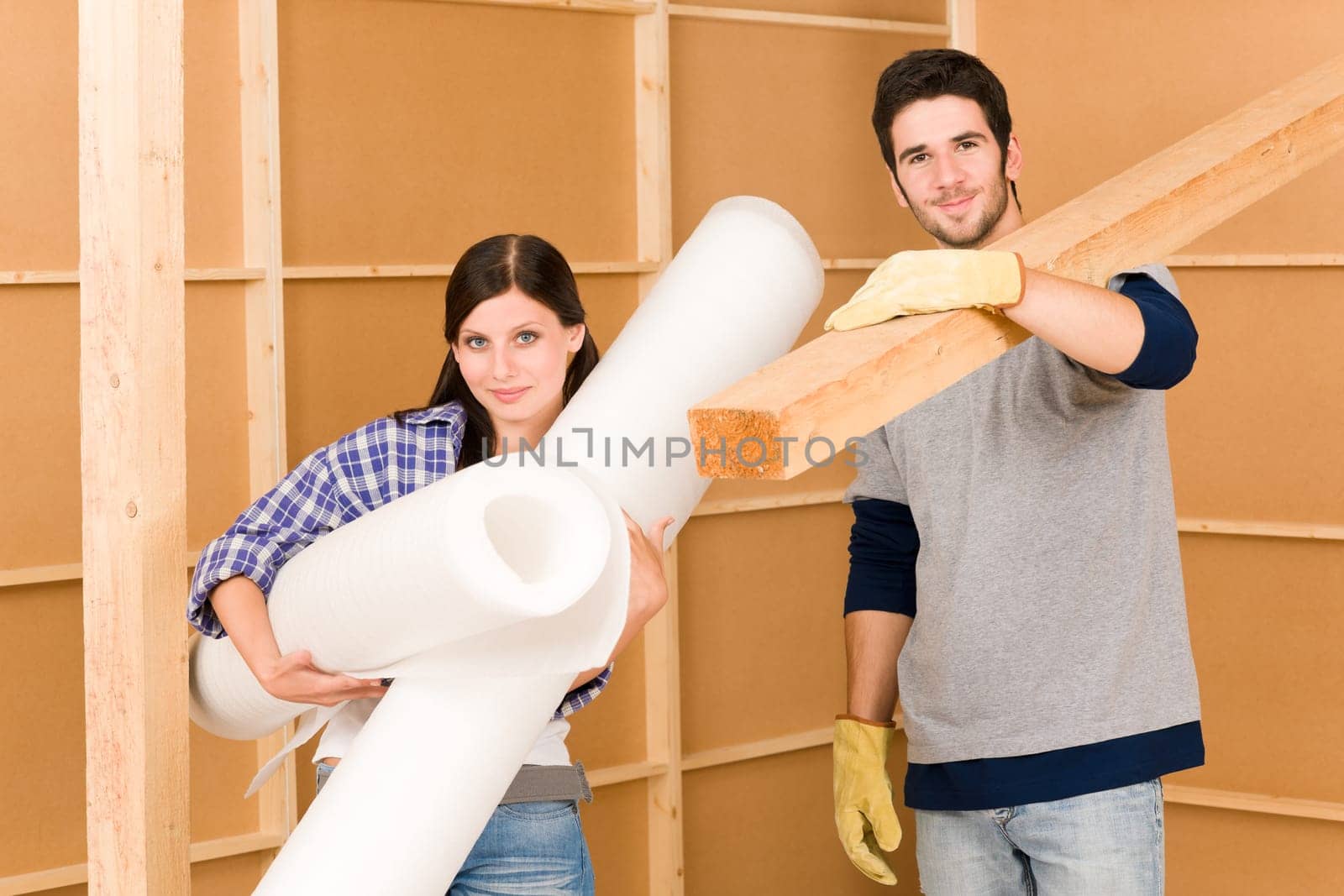 Home improvement young happy couple working on floor renovations