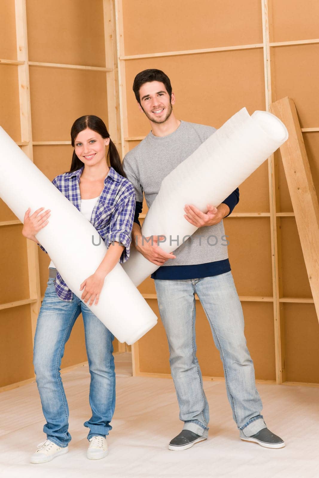 Home improvement young happy couple working on floor renovations
