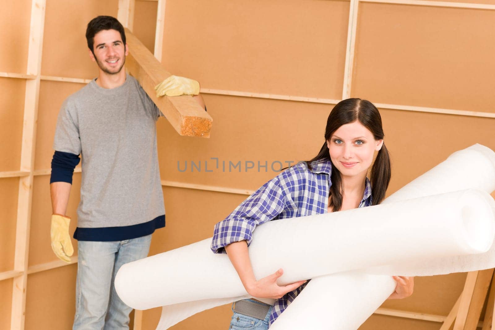 Home improvement young happy couple working on floor renovations