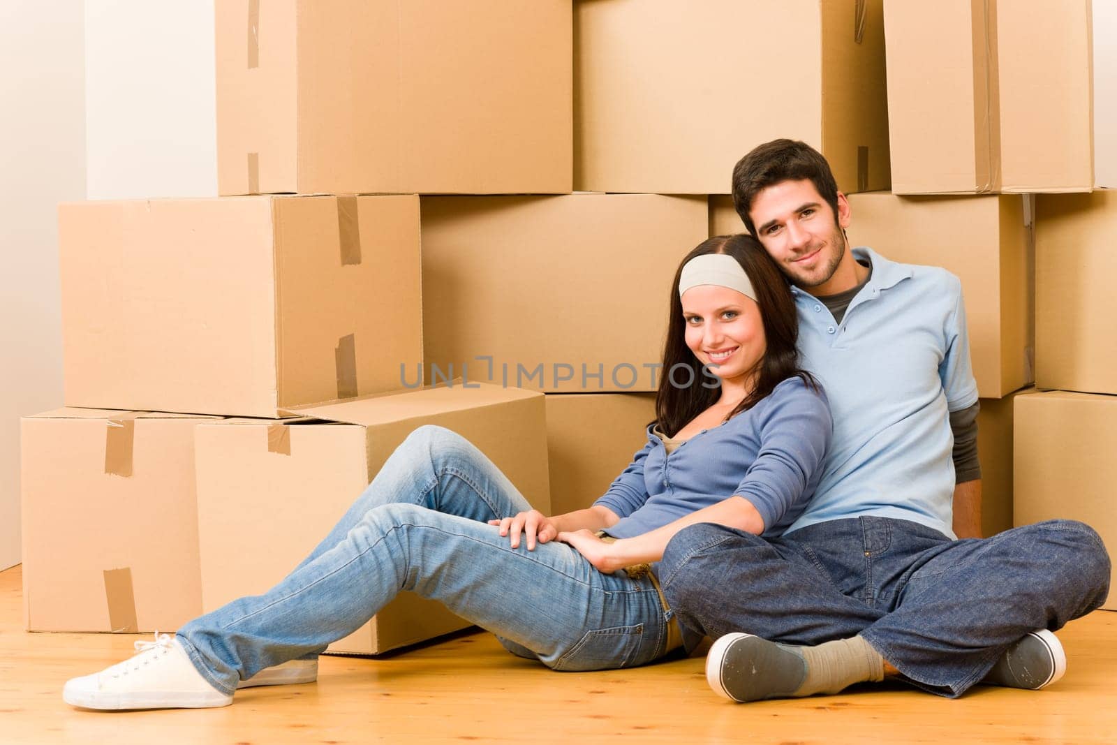 Moving into new home young happy couple sitting on floor