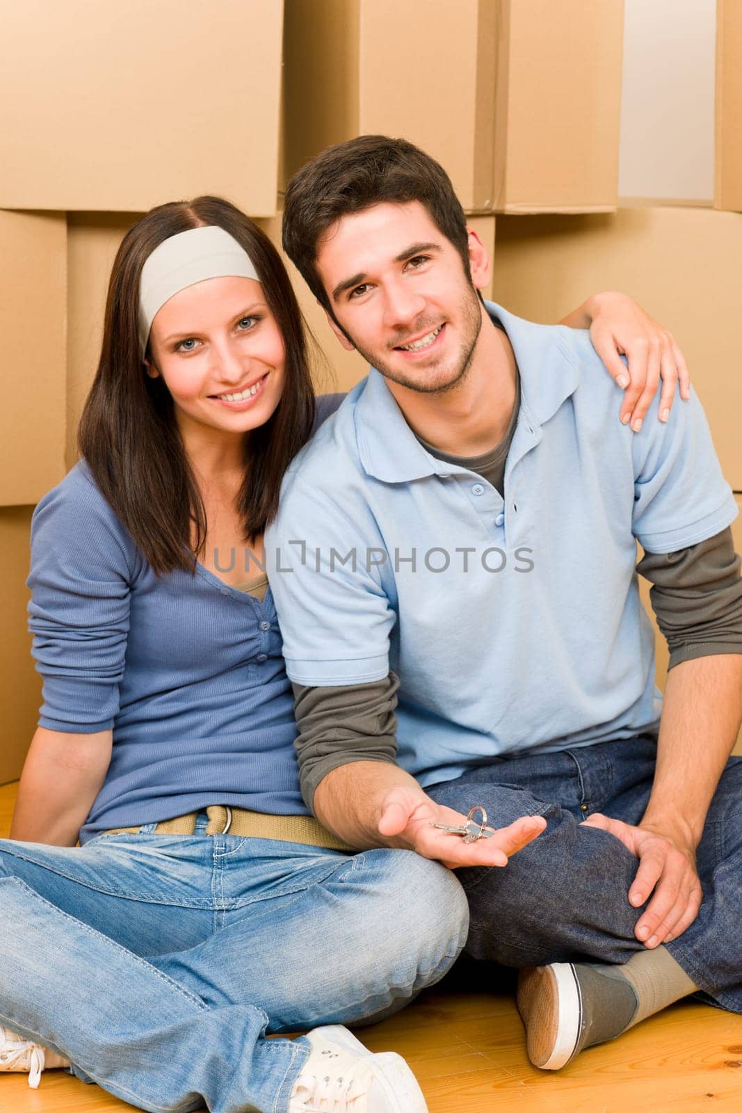 Moving into new home young happy couple holding house keys