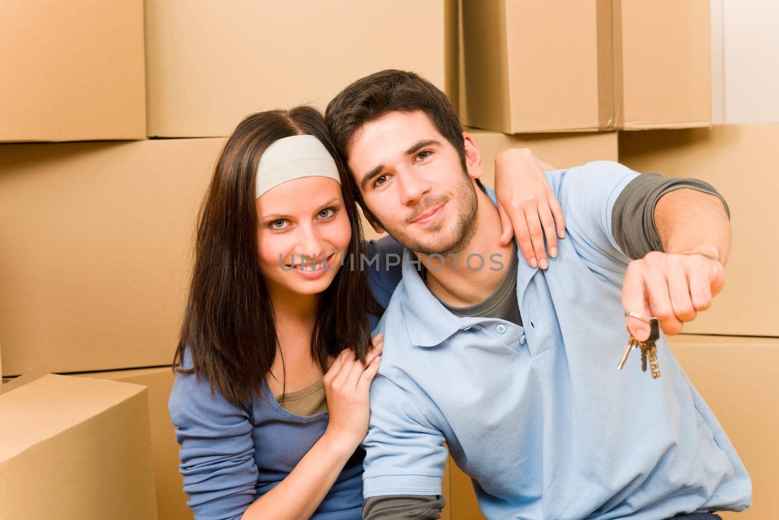 Moving into new home young happy couple holding house keys
