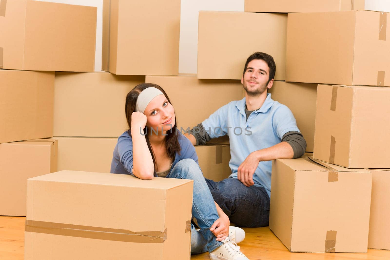Moving into new home young happy couple sitting on floor