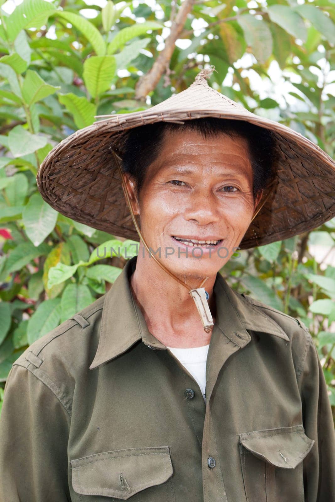 Portrait of friendly Asian,with traditional hat from Vietnam