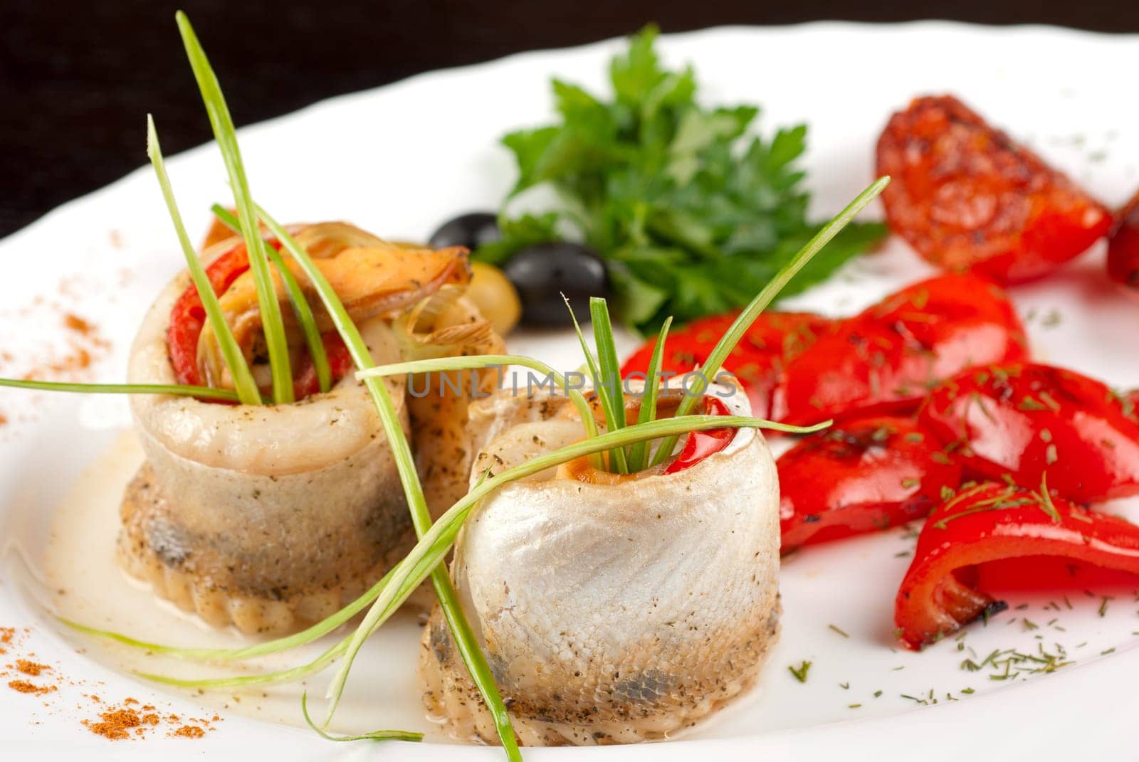 fillet of pikeperch stuffed with trout fish with baked pepper, tomato and leek