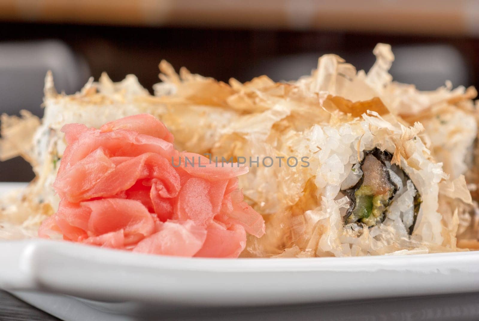 Sushi rolls of rice, nori, cream cheese, avocado, smoked salmon,cucumber and cuts of tuna