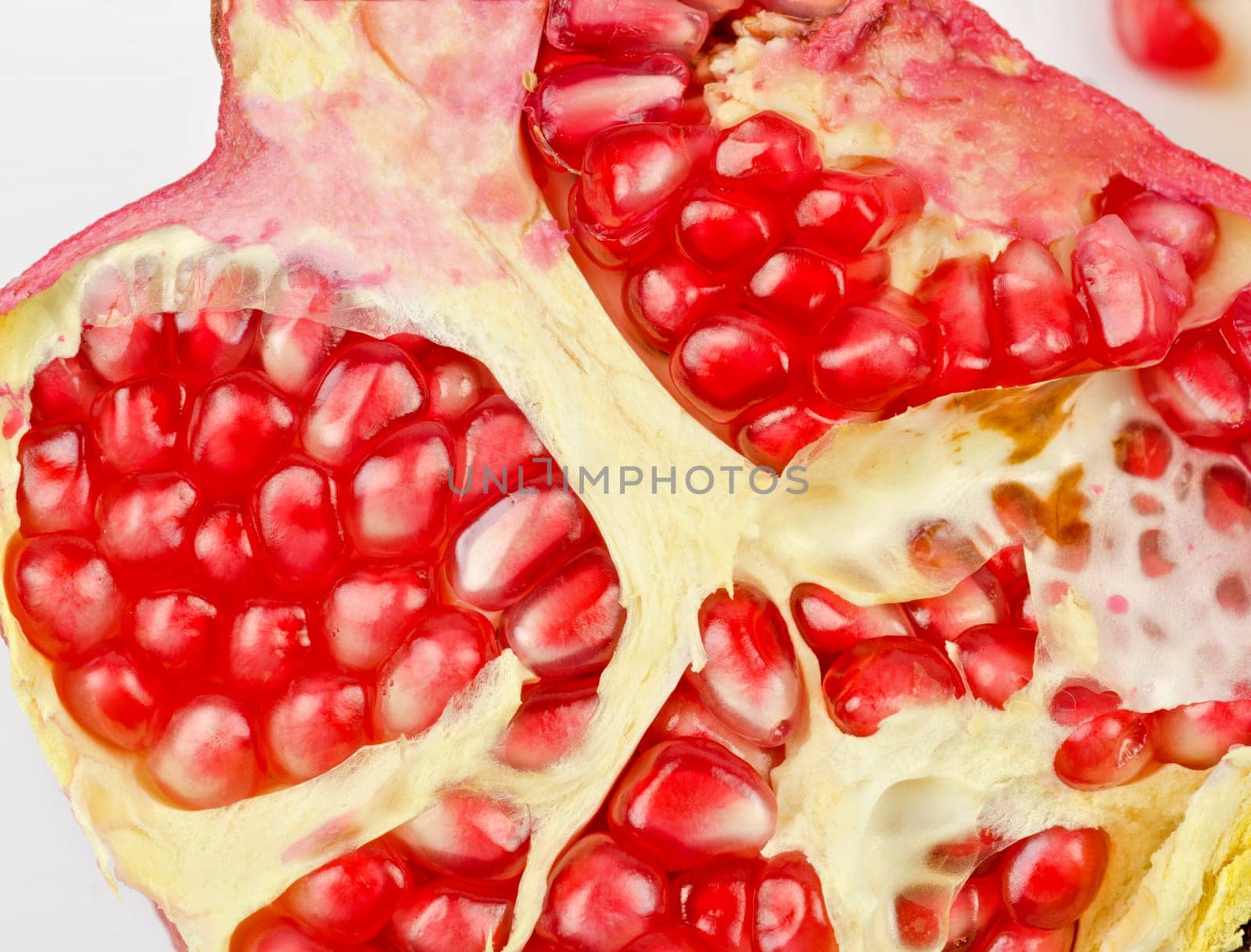 Half of pomegranate closeup on a white background