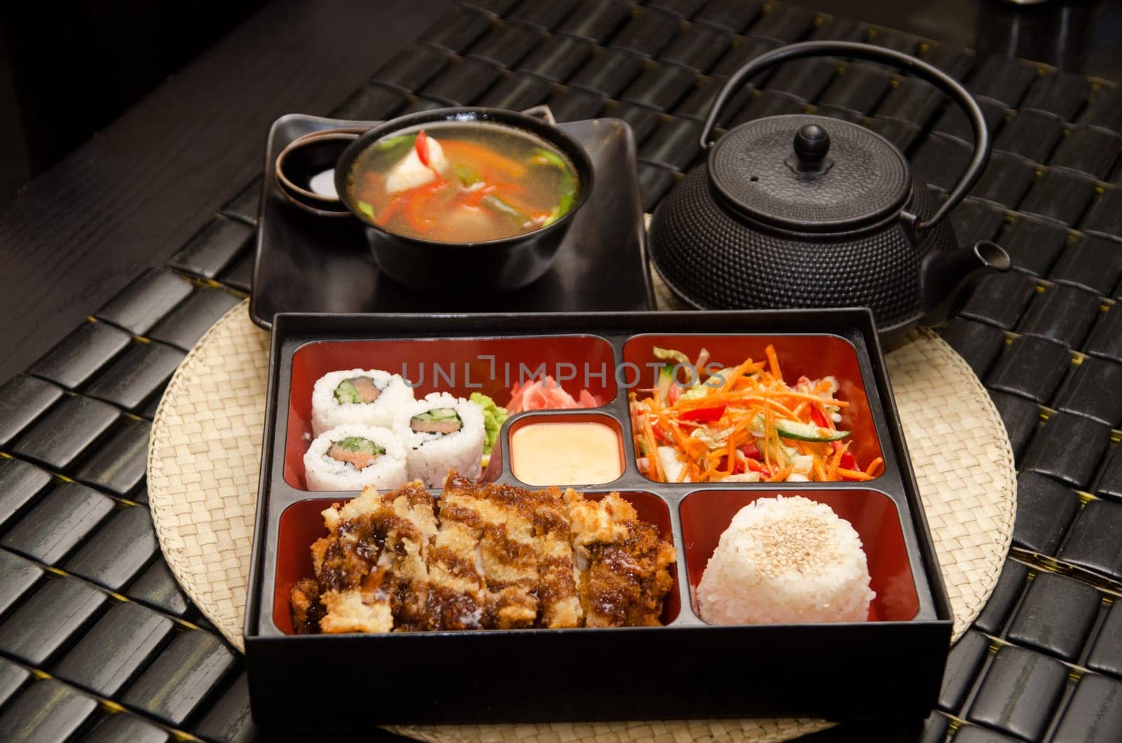 Sushi lunch with soup salad tea and sauce