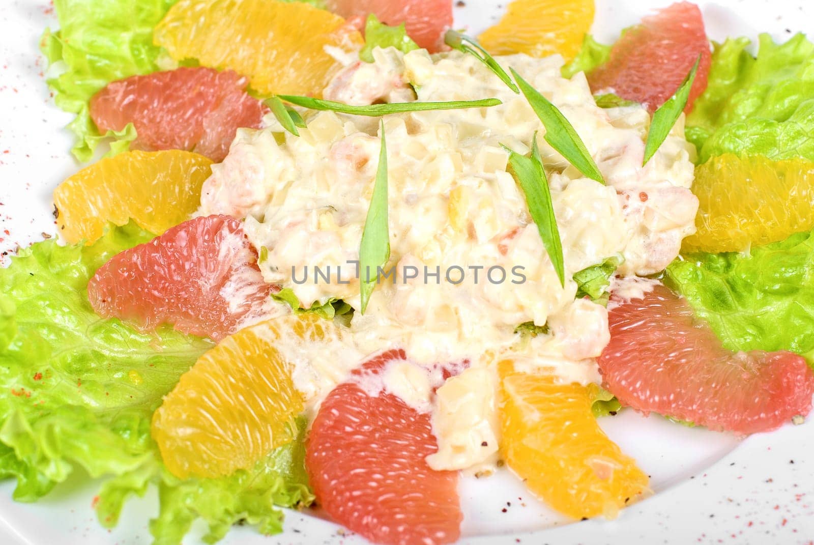 seafood salad of shrimp baked at cream with orange and grapefruit isolated on a white background