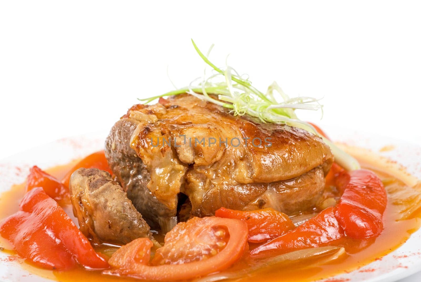 Tasty knuckle of veal baked with vegetables closeup