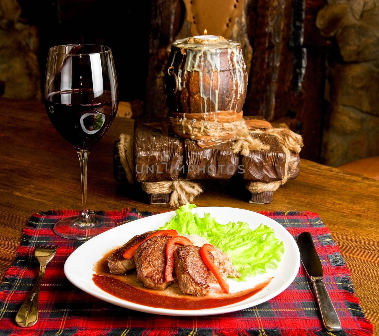 Roast maral meat with blood and garnish pearl barley at table with wine