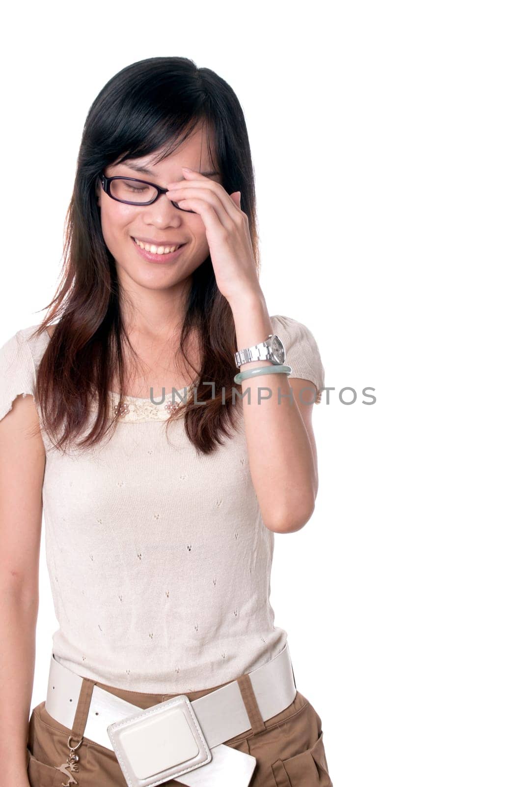 A shy girl in glasses is smiling with eyes closed isolated on white