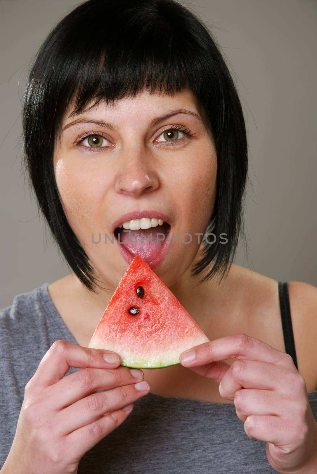 Young woman eating melon
