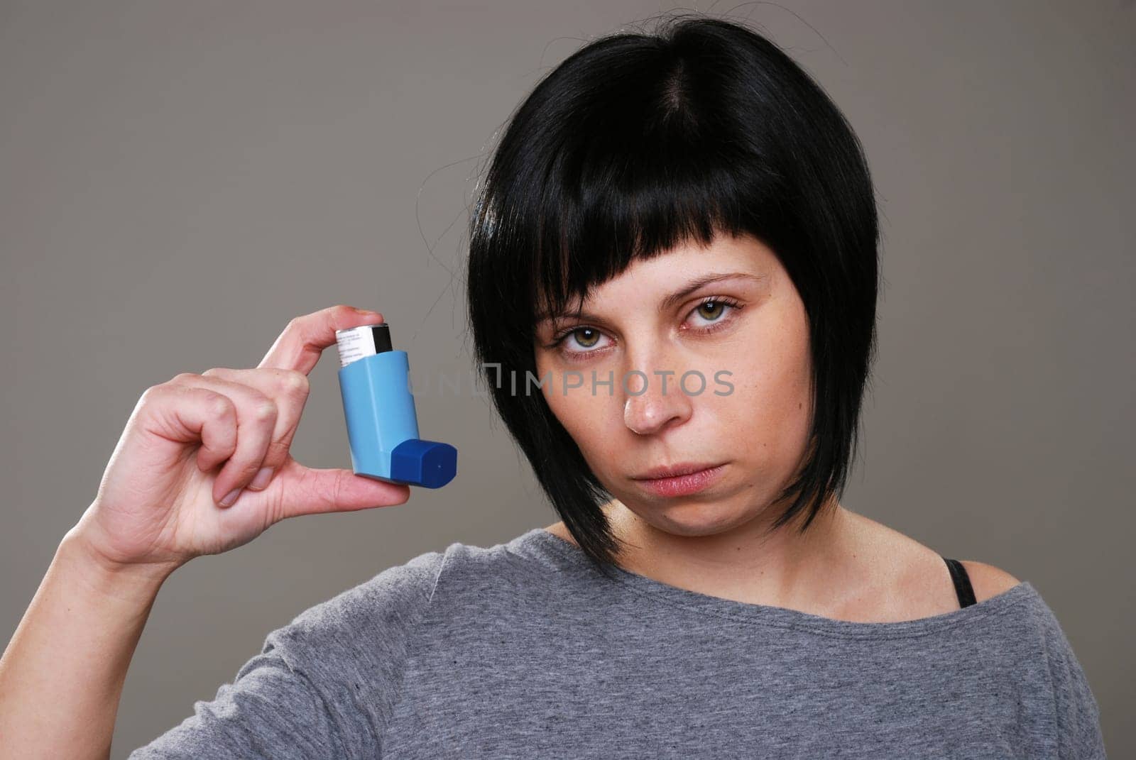 Young woman with asthma spray