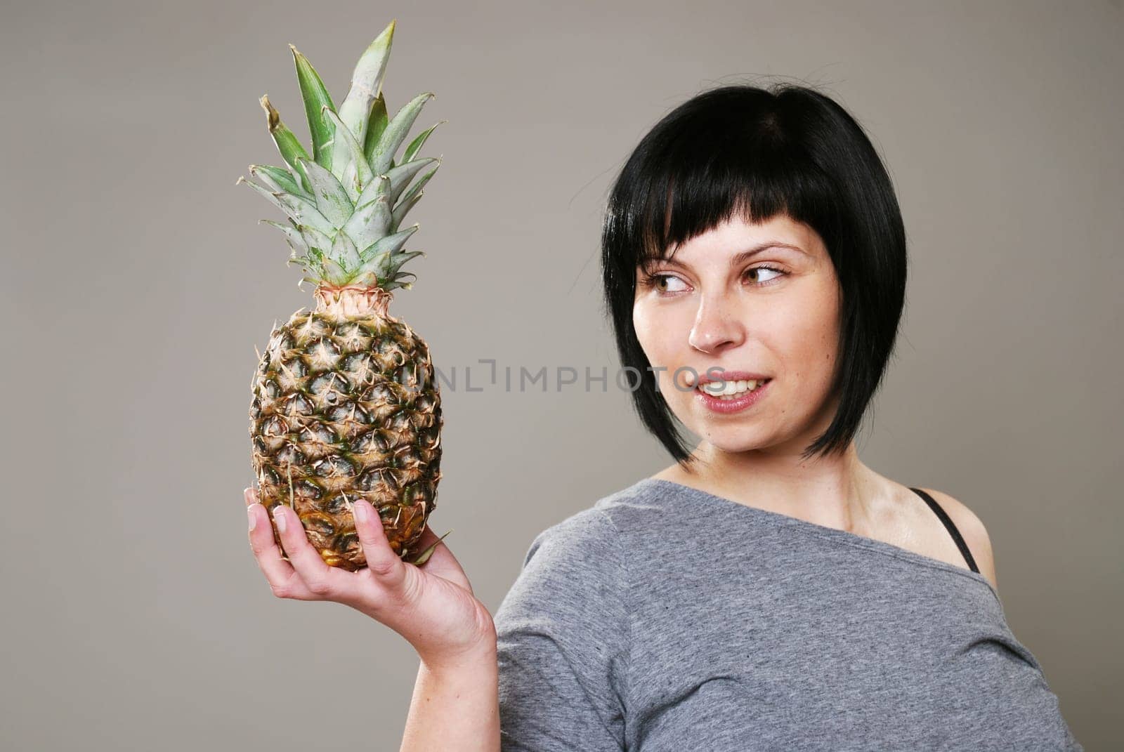 Young woman with pineapple