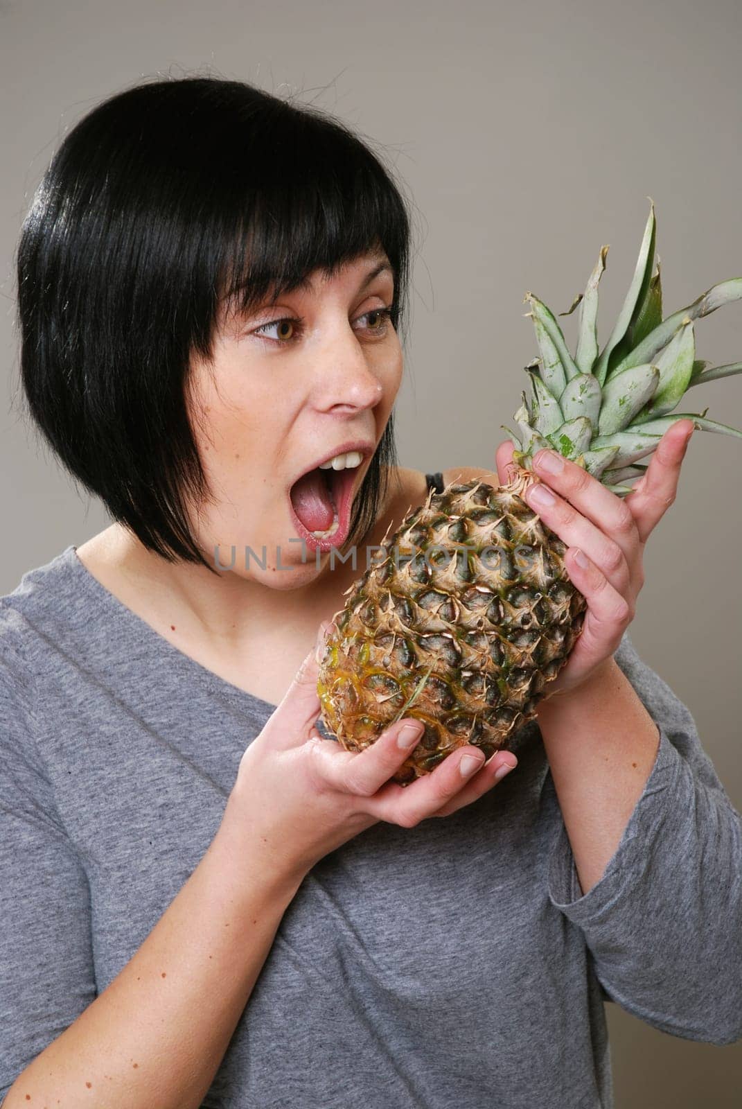 Young woman with pineapple