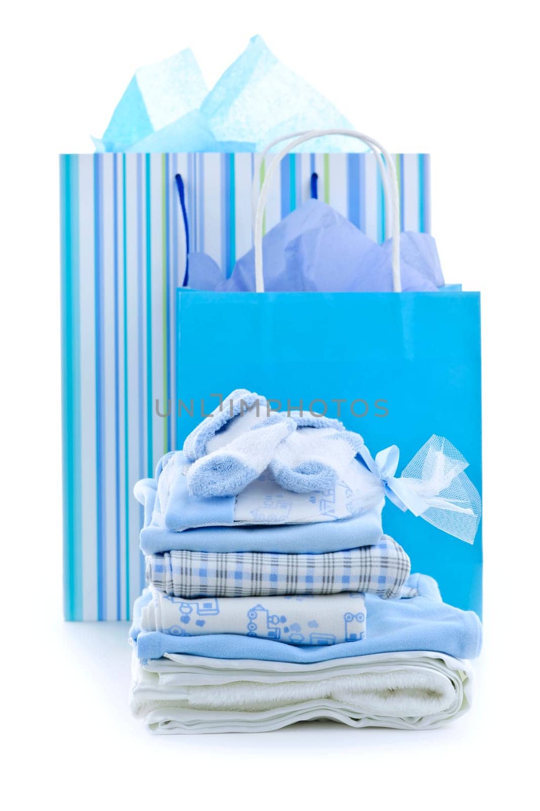 Gift bags and infant clothes for baby shower isolated on white