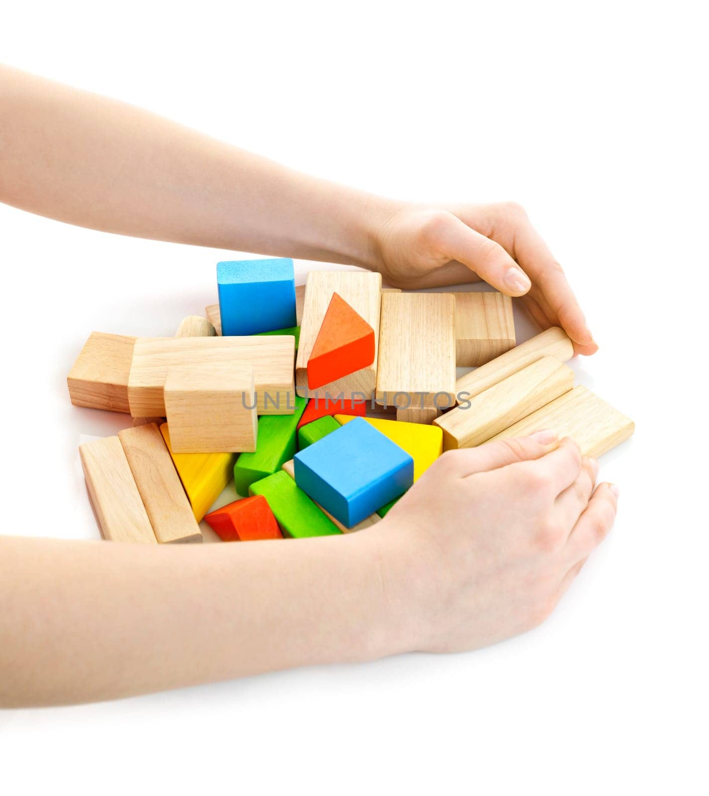 Hands gathering pile of wooden block toys isolated on white