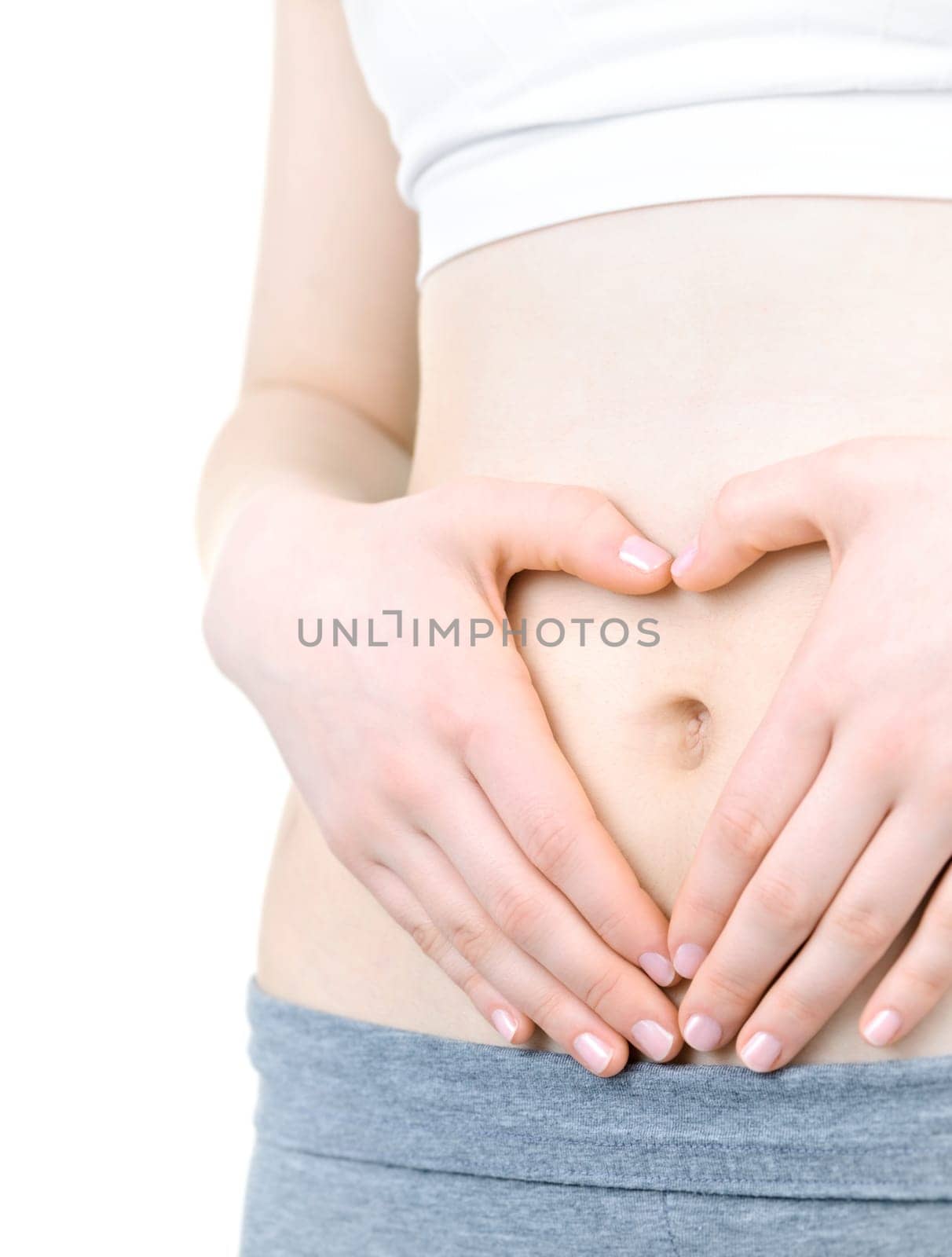 Woman showing heart shape with her hands on stomach