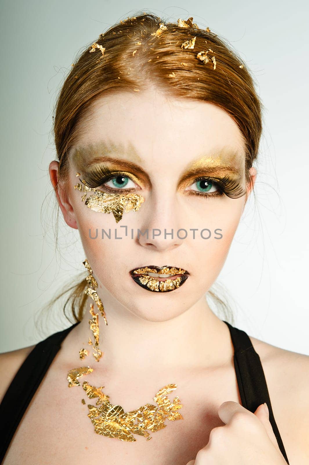 Blonde woman with leaf gold on her face