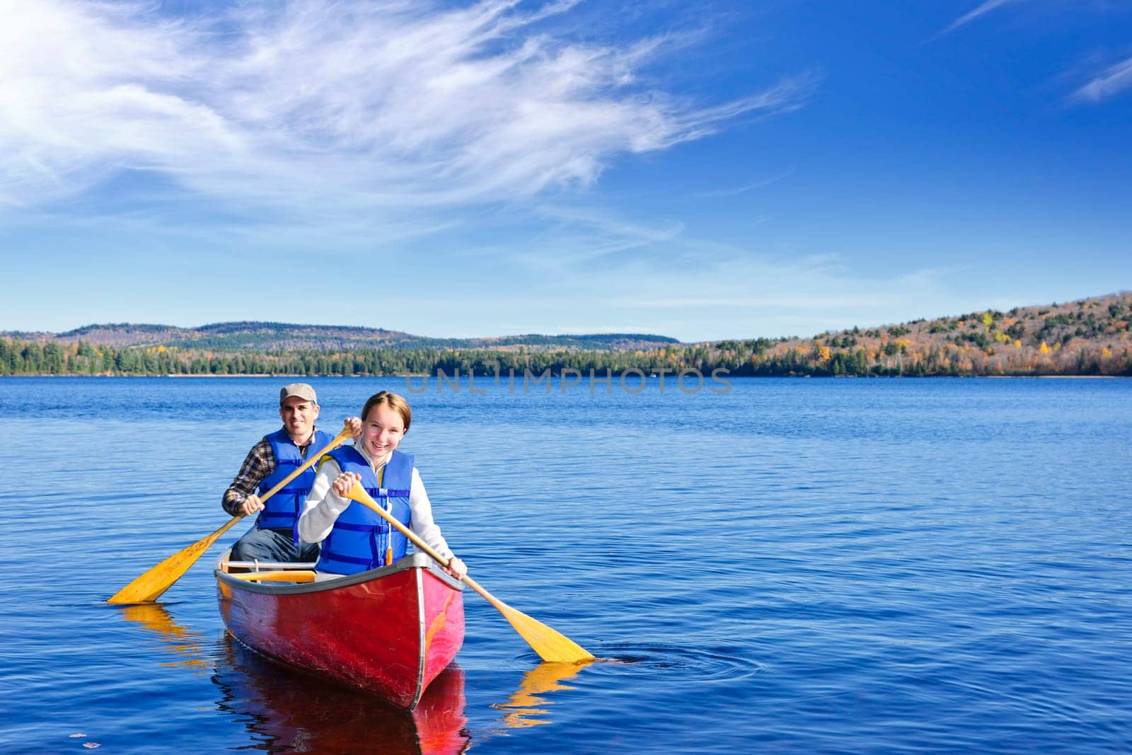 Father and daughter canoeing on Lake of Two Rivers, Ontario, Canada