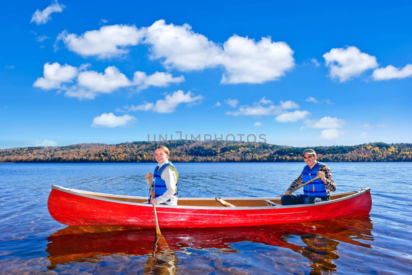 Father and daughter canoeing on Lake of Two Rivers, Ontario, Canada