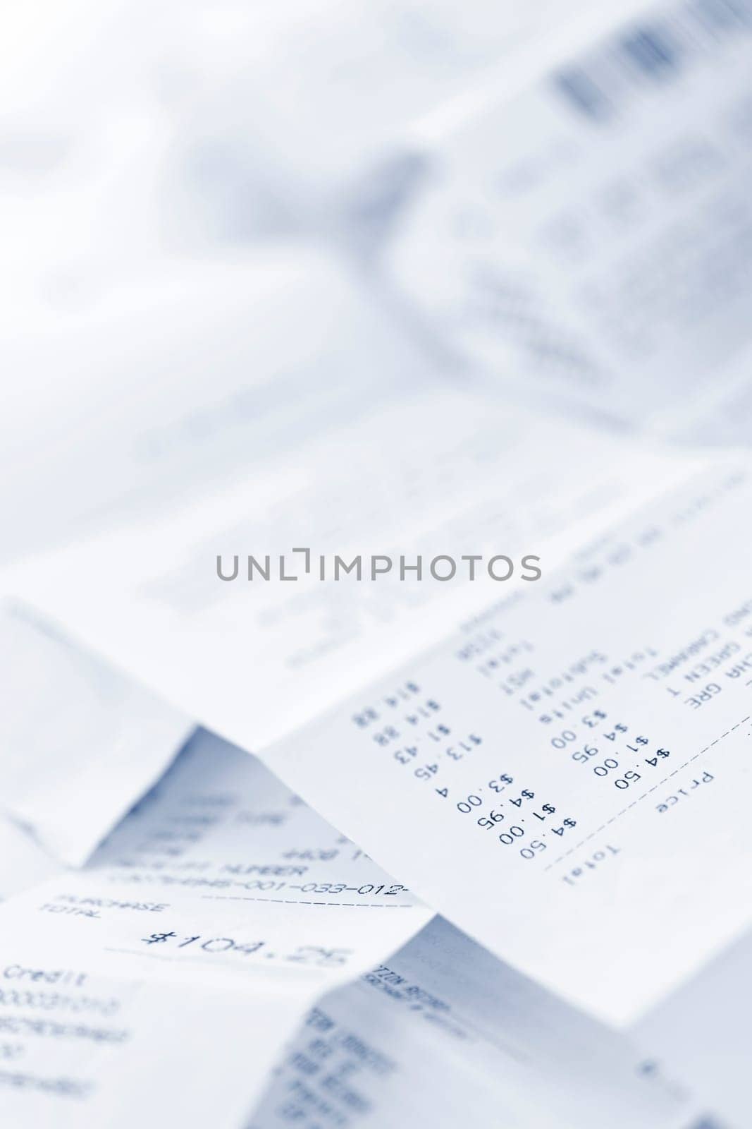 Paper cash register receipts in a lose pile close up