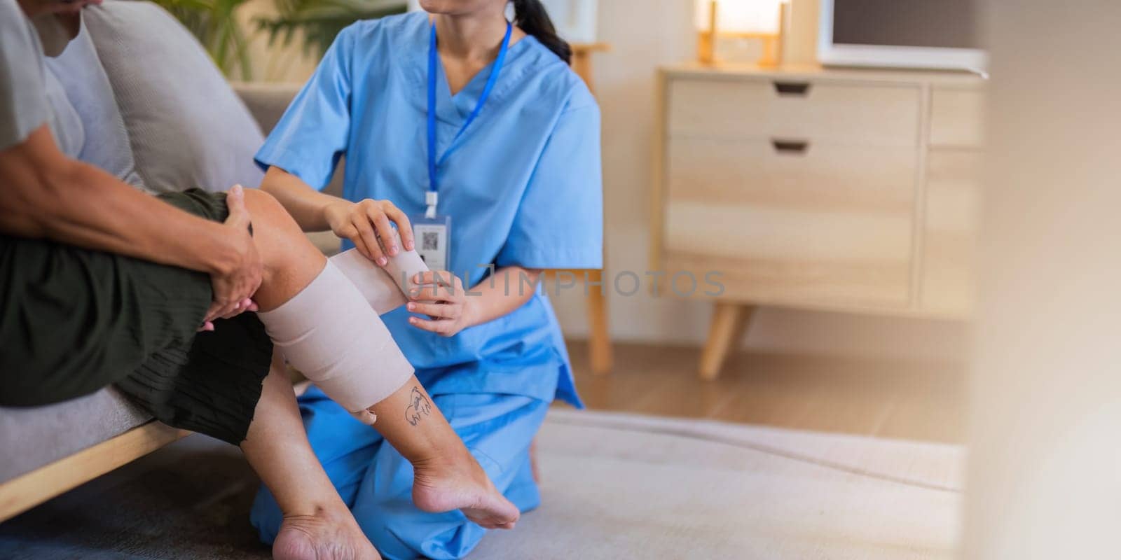 Physical therapist caregiver Asian and Caucasian senior women trust moving hand in rehabilitation. Physiotherapy healthcare, Medical caregiver consulting disabled elderly patient at home.