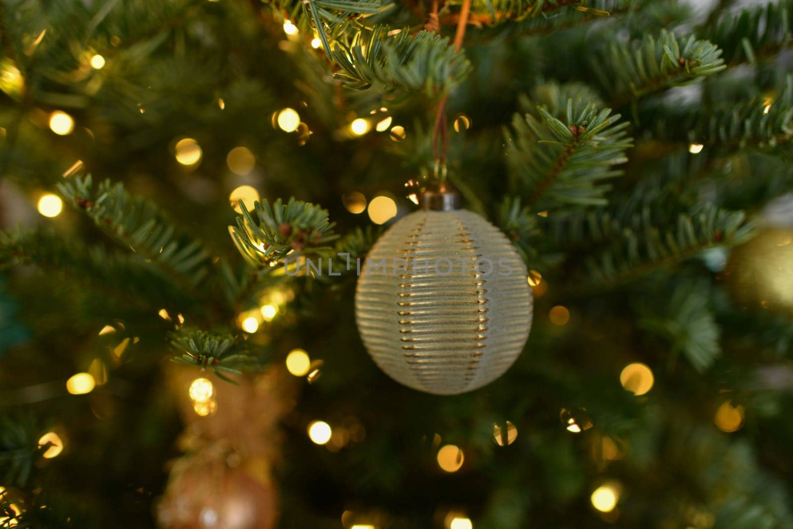 Green ball toys hanging on a Christmas tree