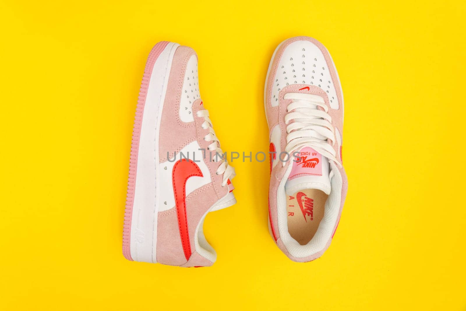 Tyumen, Russia-August 10, 2023: Nike Air Force 1 Valentines Day. Yellow background. Flat lay by darksoul72