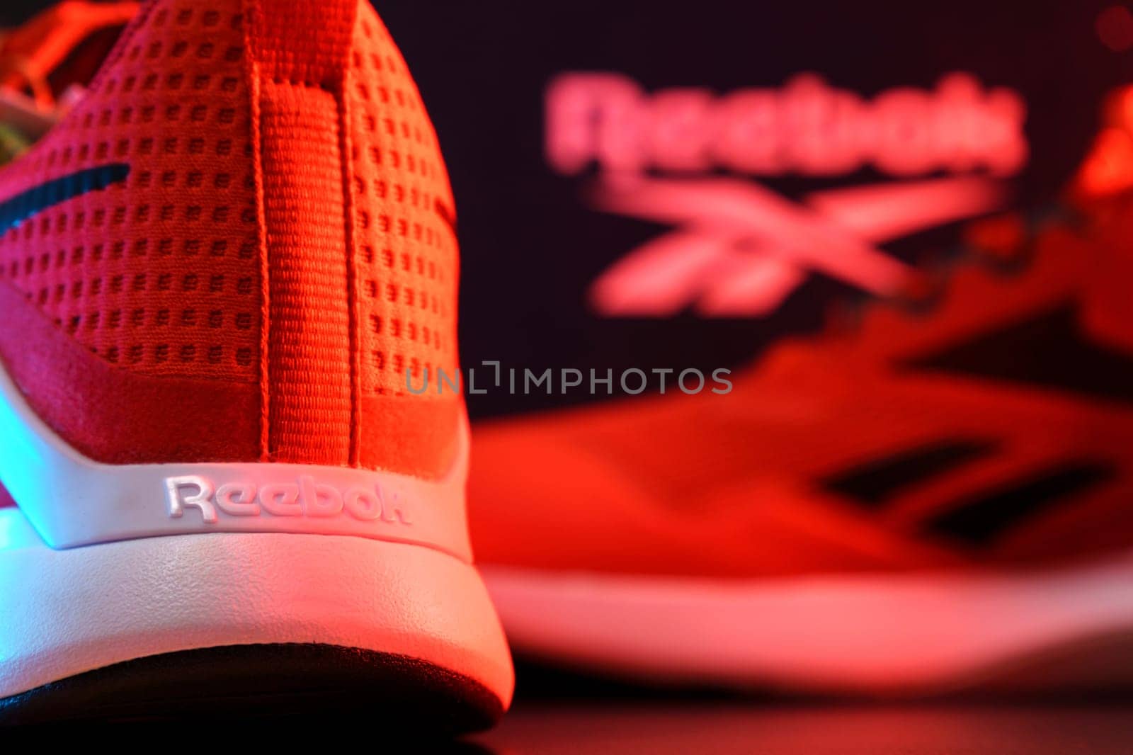 Tyumen, Russia-August 03, 2023: Reebok mens model Nanoflex in the red light. Selective focus