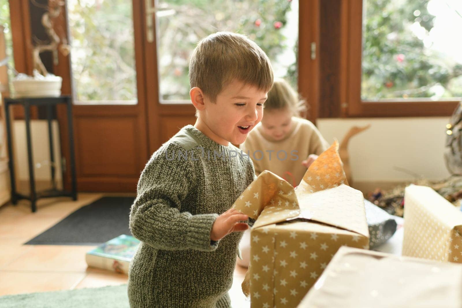 A boy is surprised with a christmas present by Godi