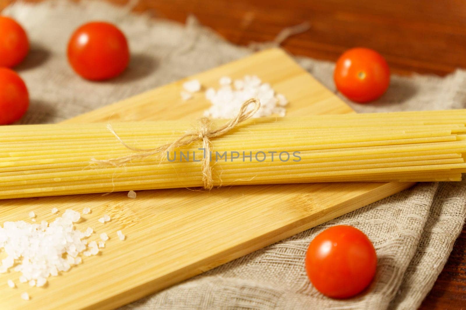 Pasta view of dy authentic Italian spaghetti, cooking with cherry tomatoes