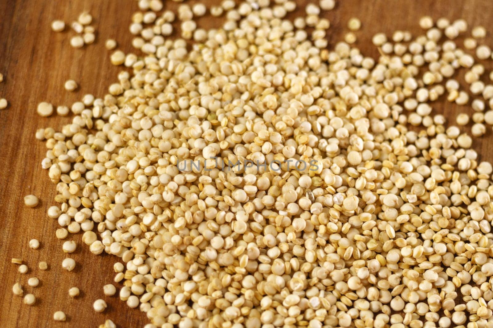 White quinoa uncooked seeds texture close up macro. Selective focus.