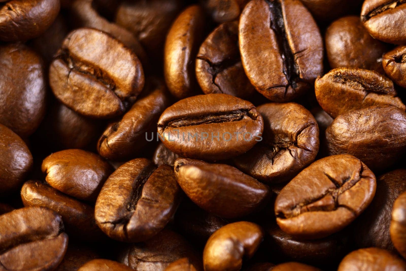 Roasted coffee beans, on a dark background. Espresso dark, aroma, black caffeine drink. Close up by darksoul72