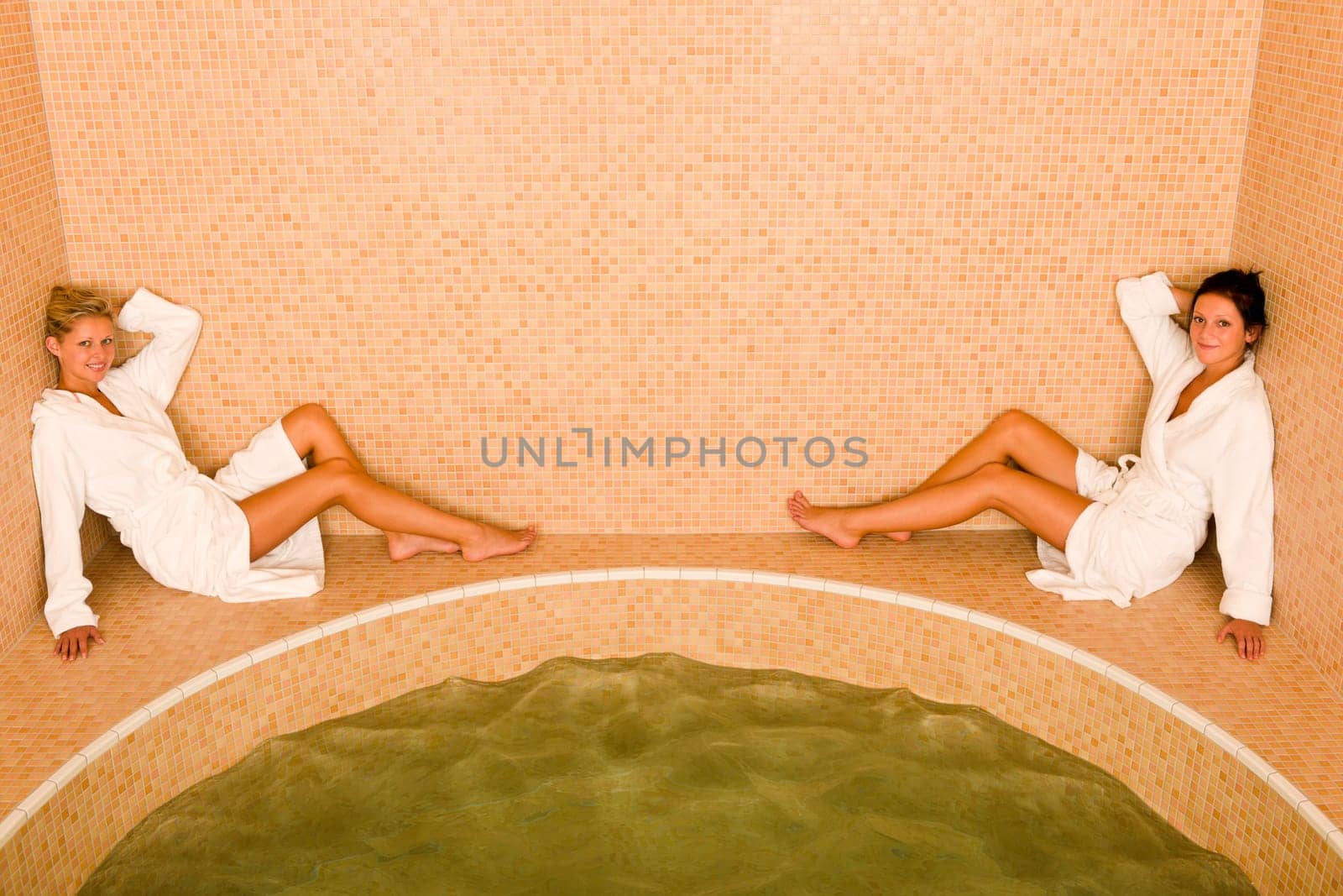 Relax bath spa two beautiful women sitting by water jacuzzi
