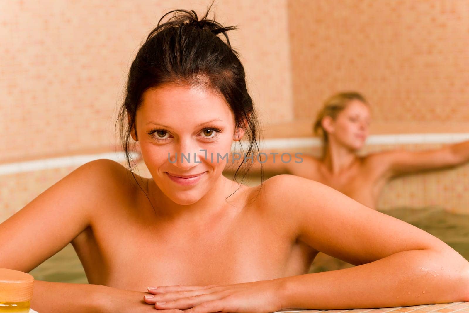 Relax spa pool two naked women inside water beauty health