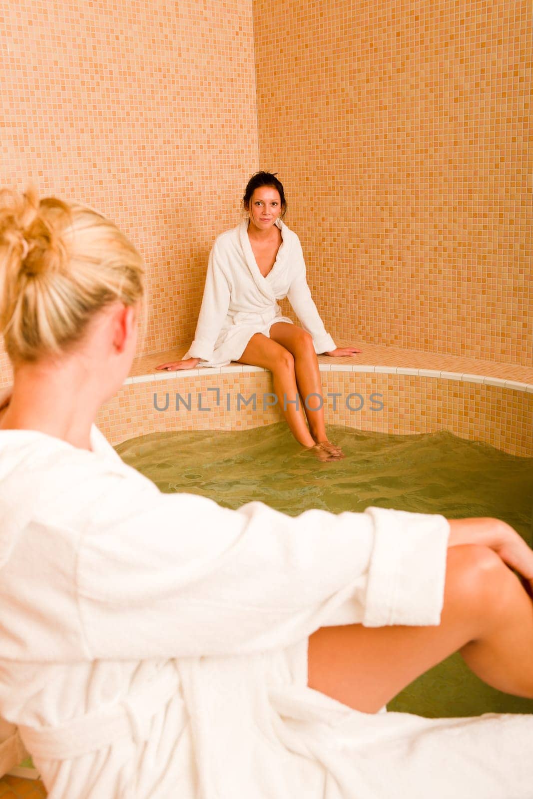 Relax bath healthy spa two beauty woman sitting bathrobe pool
