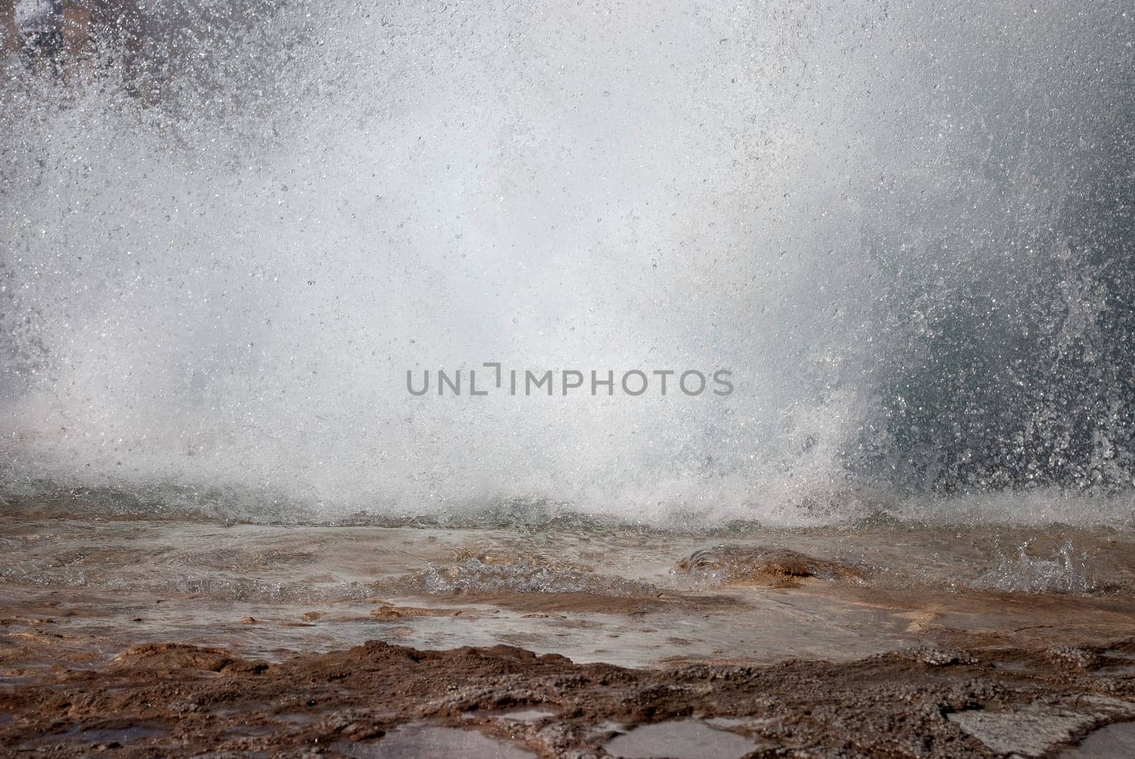 detail of the base of a geyser erupting