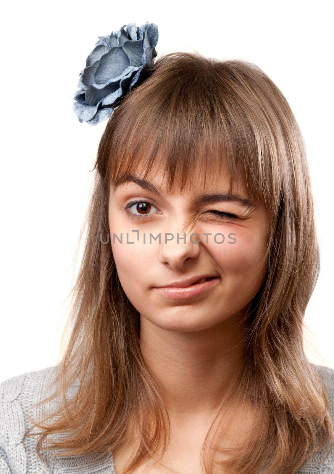 Portrait of the young girl in flower in hair on white background