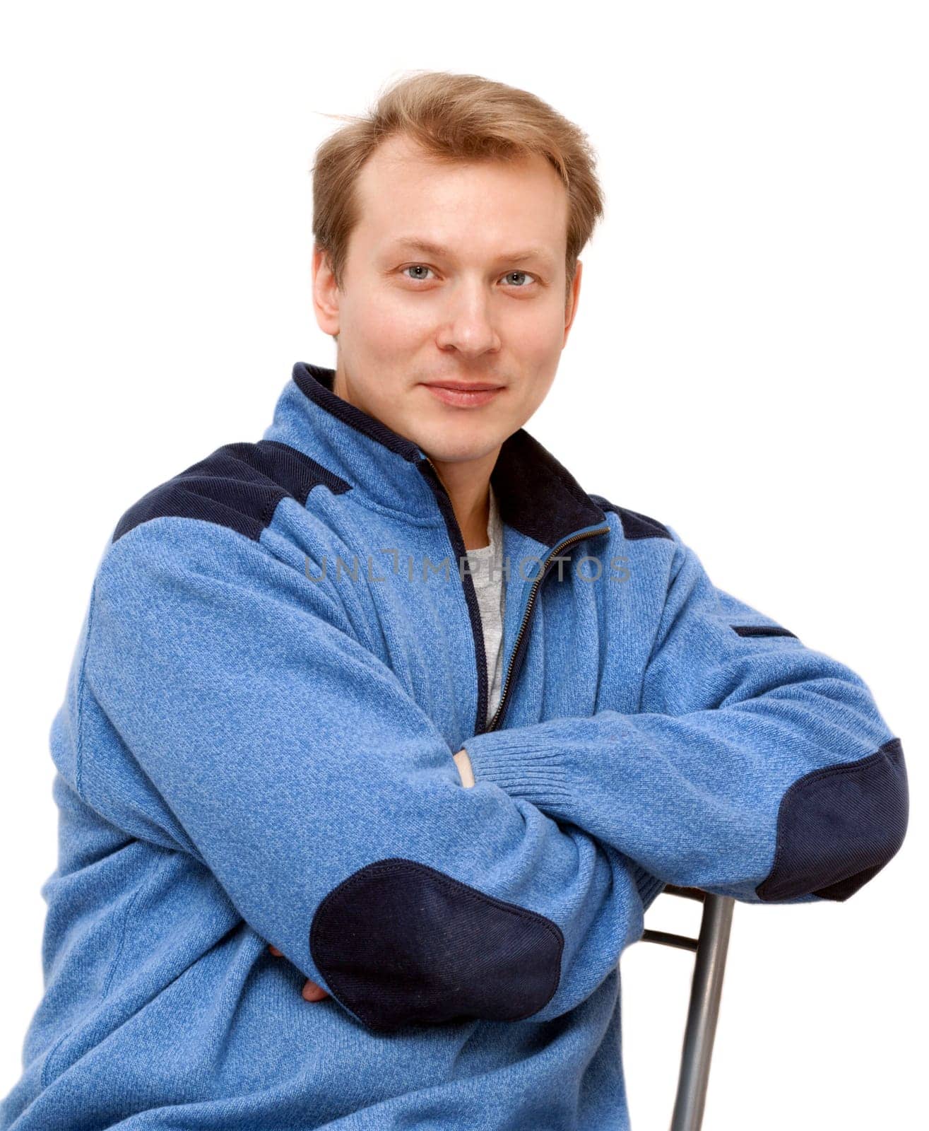 Portrait men blond sits on chair on gray background