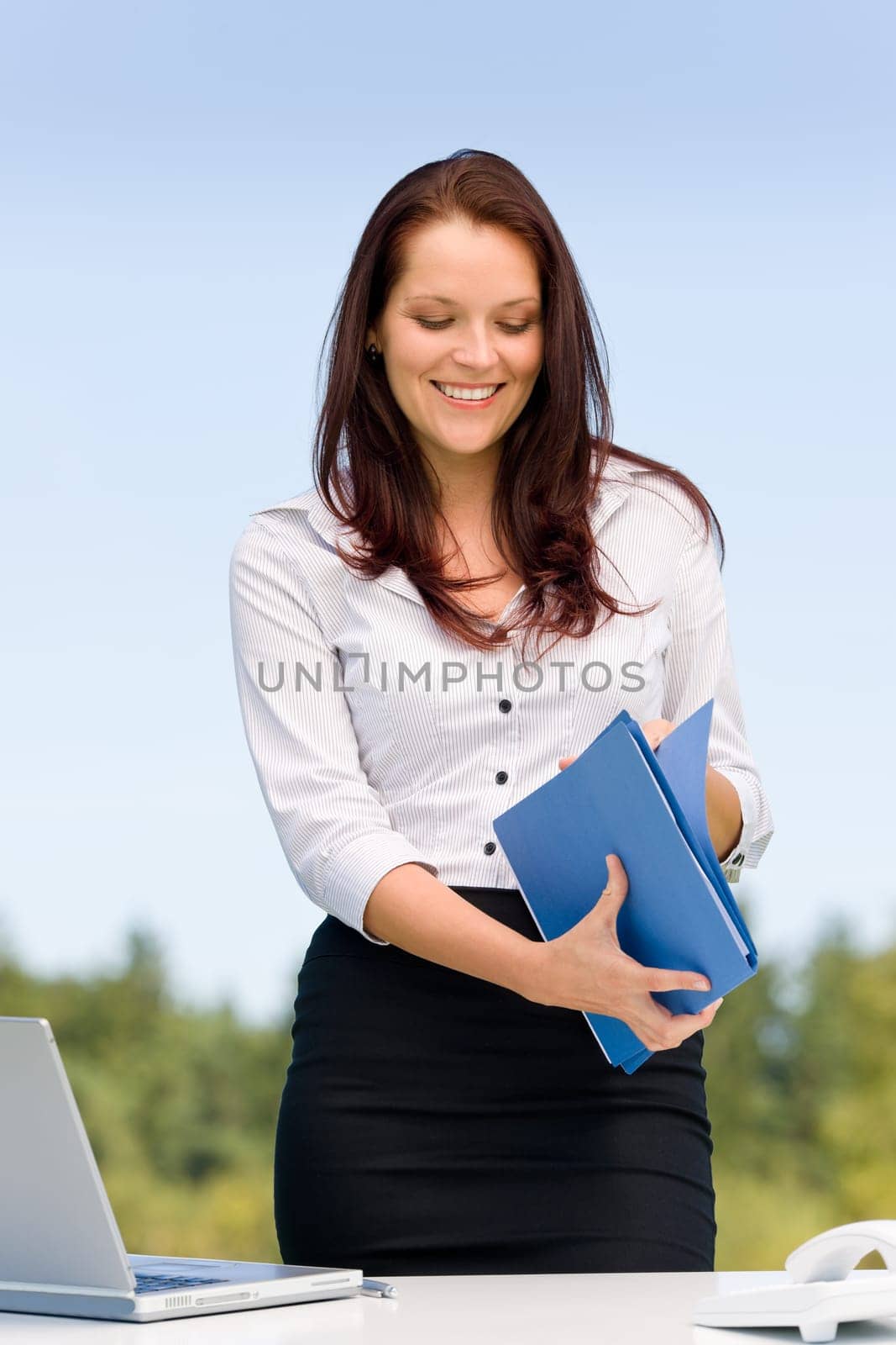 Young businesswoman in sunny nature attractive smiling hold folders