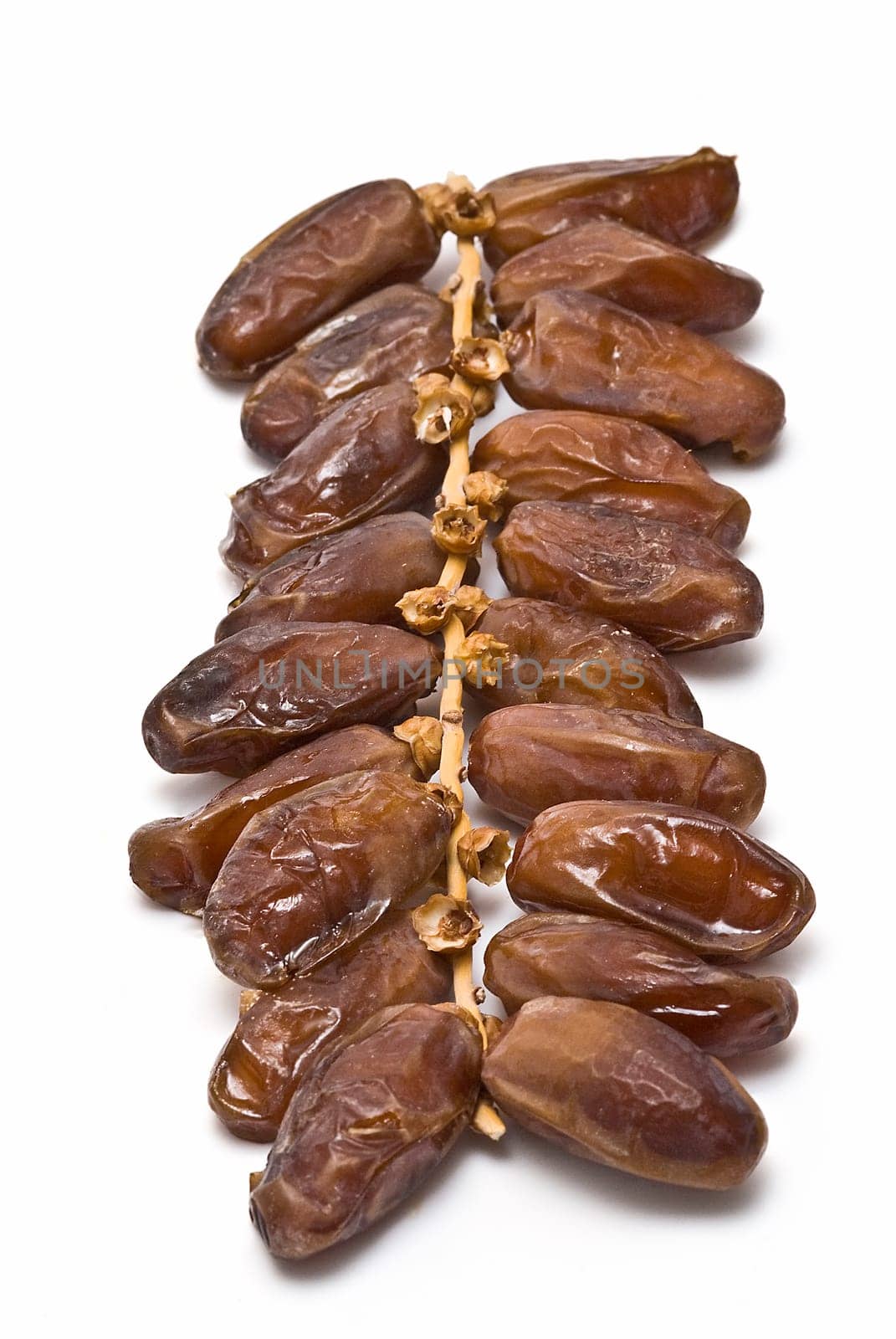 Date fruit isolated over a white background.